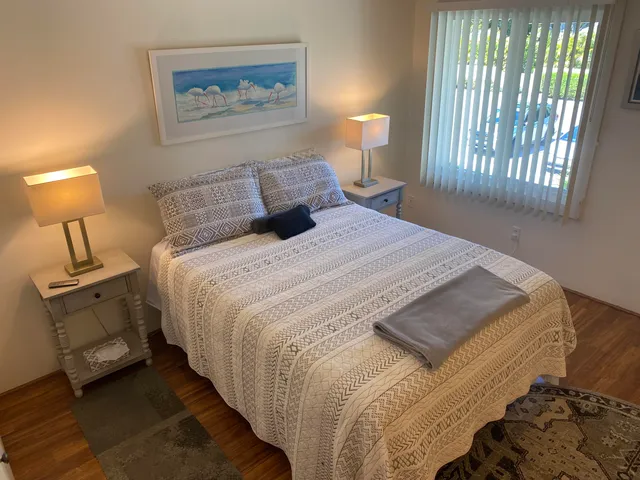 a bedroom with a bed and a lamp