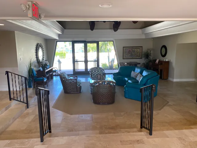 a living room with furniture a rug and a large window