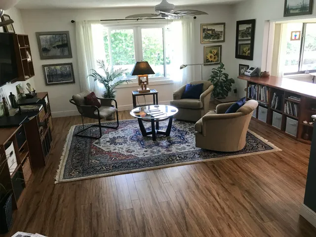a living room with furniture a window and a table