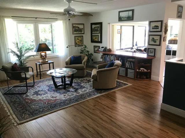 a living room with furniture and wooden floor