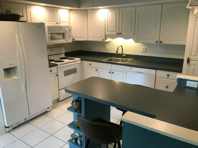 a kitchen with stainless steel appliances a stove a refrigerator and cabinets