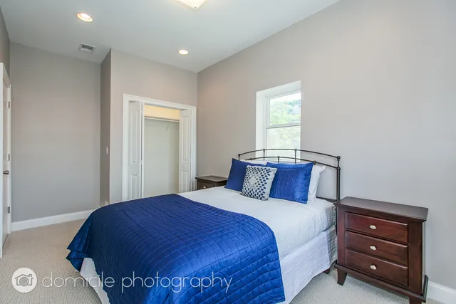 a bedroom with a bed and a window