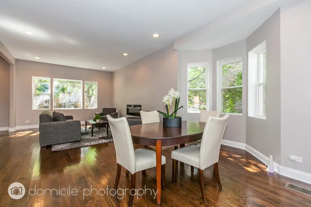 a view of a dining room with furniture a chandelier and wooden floor