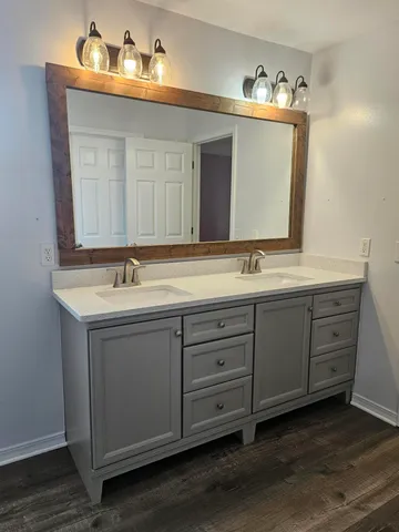 a bathroom with a double vanity sink and a mirror