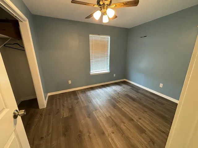 wooden floor in an empty room with a window