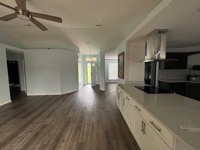 a view of a kitchen with a sink and wooden floor
