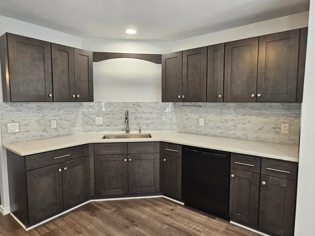 a kitchen with wooden cabinets