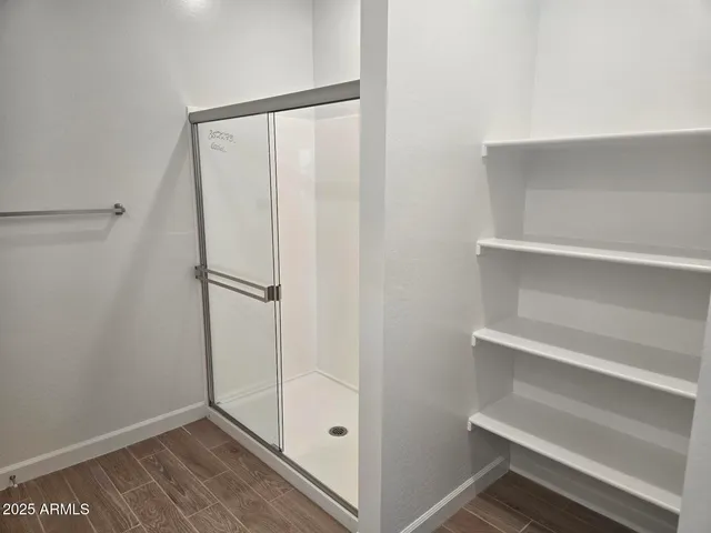 a room with a closet and a potted plant