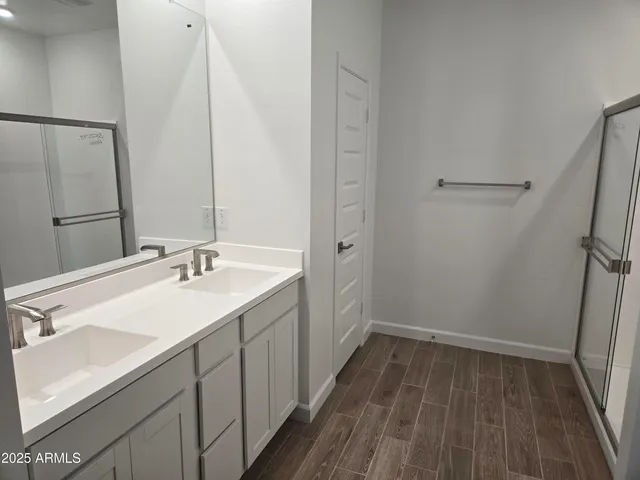 a bathroom with a double vanity sink and a mirror