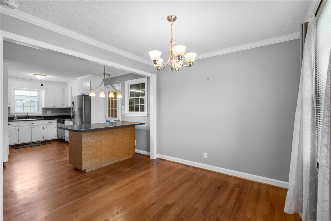 300 Green Street Williamston, SC 29697 - Photo 8 of 47 Hardwood floors and bright lighting extend throughout this inviting, open-concept dining space.