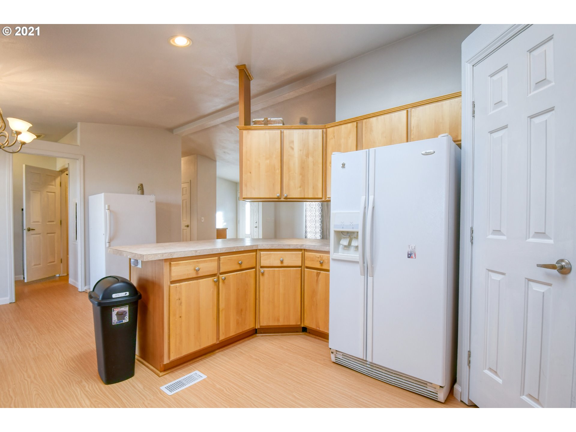 3085 Southwest River View Drive Pendleton, OR 97801 - Photo 7 of 32 a kitchen with stainless steel appliances a refrigerator sink and white cabinets