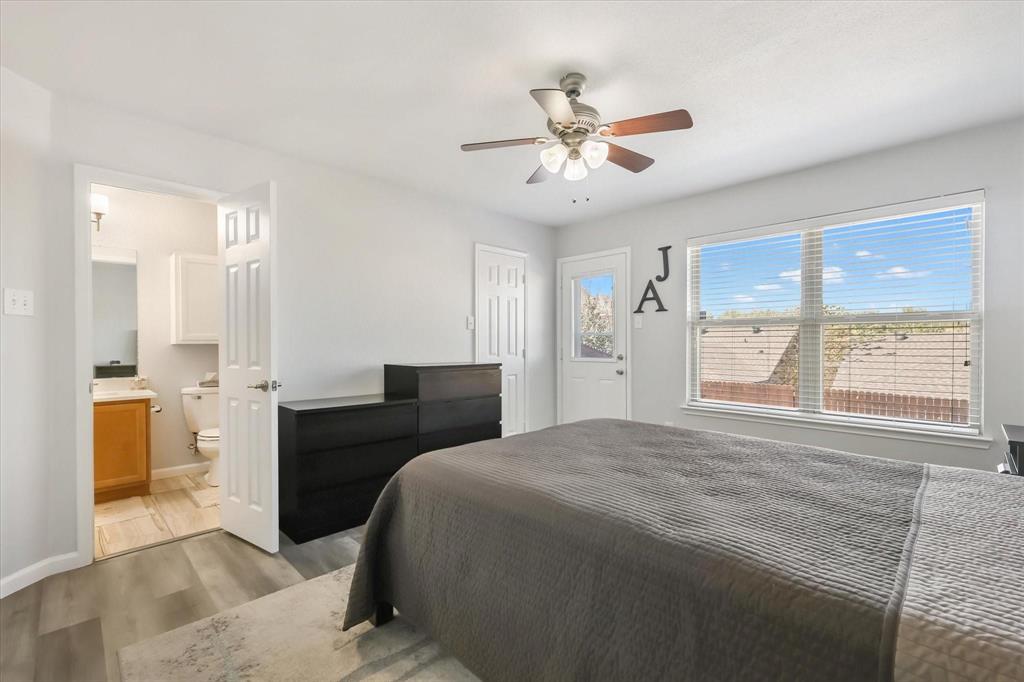 10718 Edgewest Terrace Fort Worth, TX 76108 - Photo 11 of 15 a bedroom with a large bed and a chandelier