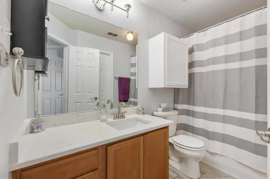 10718 Edgewest Terrace Fort Worth, TX 76108 - Photo 8 of 15 a bathroom with a sink toilet a mirror and shower