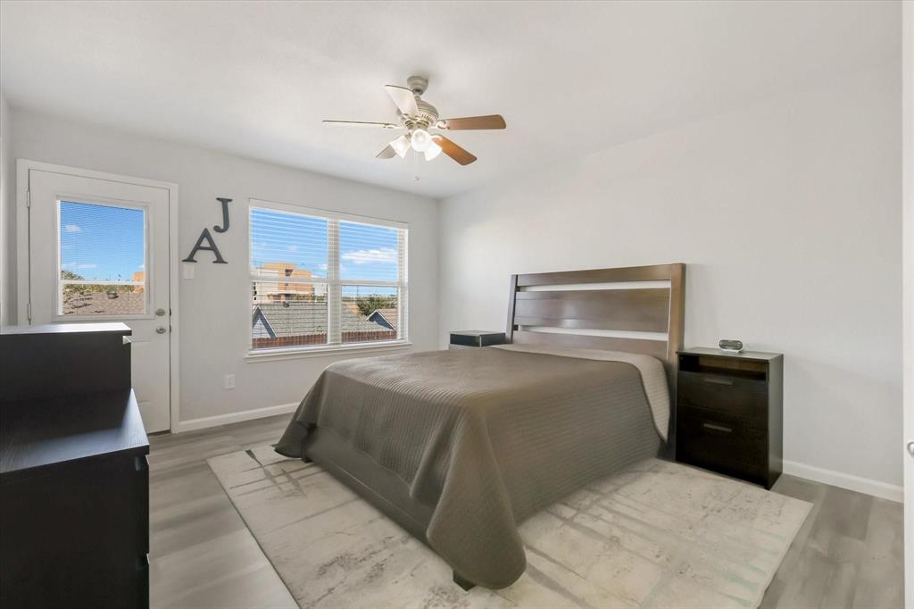 10718 Edgewest Terrace Fort Worth, TX 76108 - Photo 10 of 15 a bedroom with a bed and a chandelier