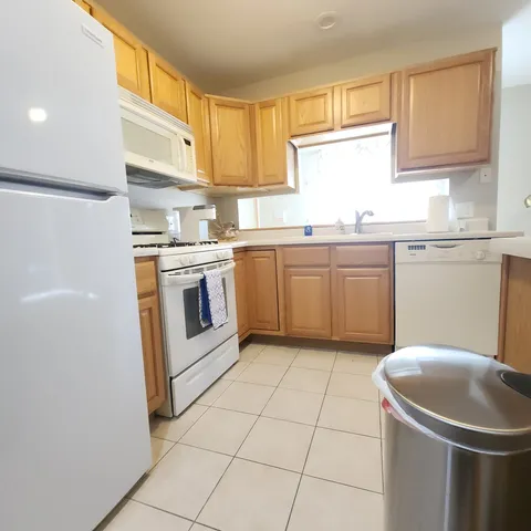 a kitchen with a sink a stove a microwave and cabinets
