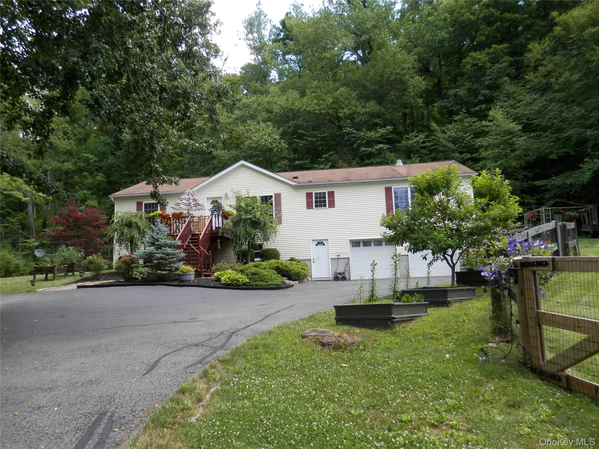 590 Farm To Market Road Brewster, NY 10509 - Photo 1 of 32 a front view of a house with garden