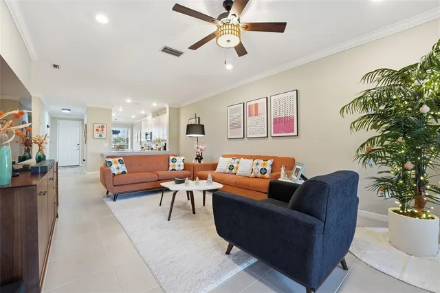 a living room with furniture and a potted plant