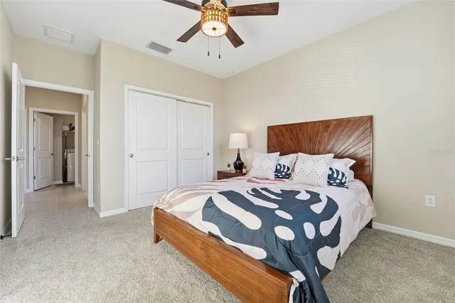 a bedroom with a bed and ceiling fan