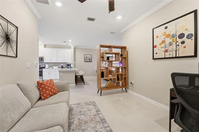 a living room with furniture and view of kitchen