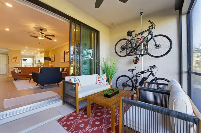 a view of a livingroom with furniture and lots of mirrors