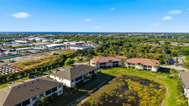 an aerial view of a city with lots of residential buildings and ocean view