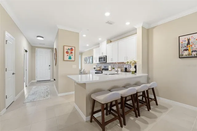 a kitchen with stainless steel appliances granite countertop a sink and a refrigerator