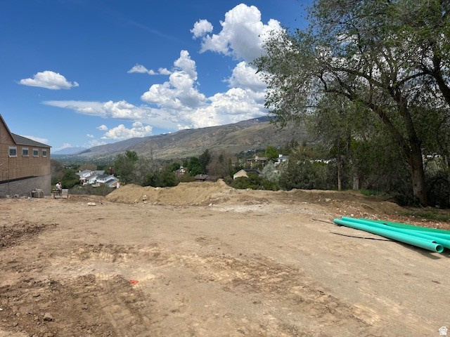 795 Abby Lane, Unit 5 Bountiful, UT 84010 - Photo 3 of 9 Cleared building lot featuring a mountainous backdrop and distant residential structures
