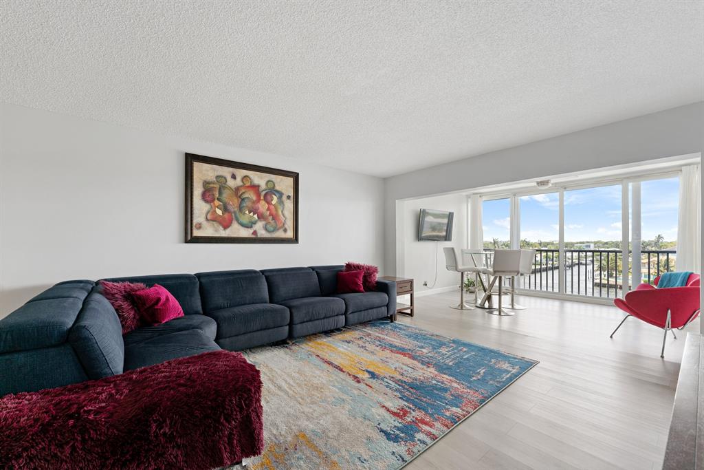 615 North Riverside Drive, Unit 502 Pompano Beach, FL 33062 - Photo 11 of 43 a living room with furniture and a rug