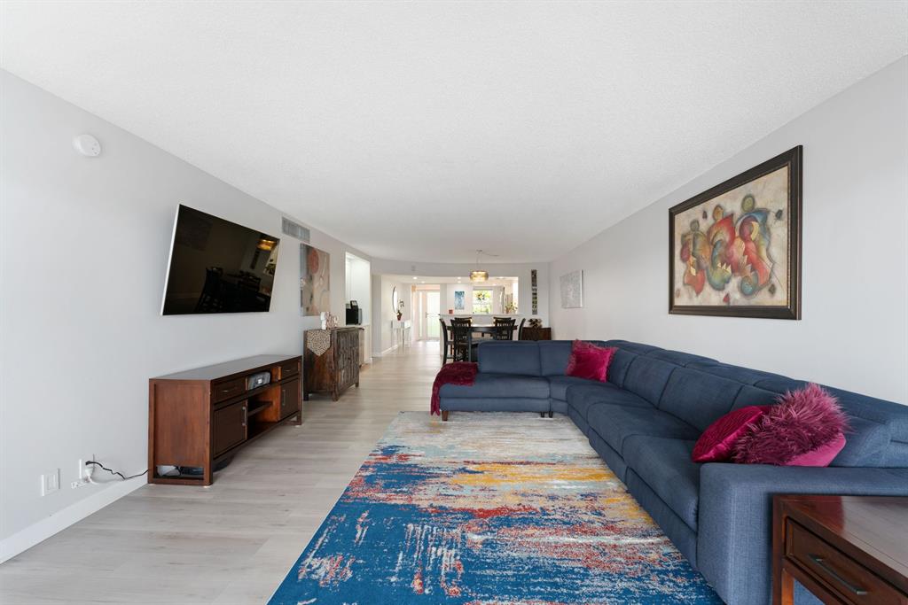 615 North Riverside Drive, Unit 502 Pompano Beach, FL 33062 - Photo 15 of 43 a living room with furniture and a flat screen tv