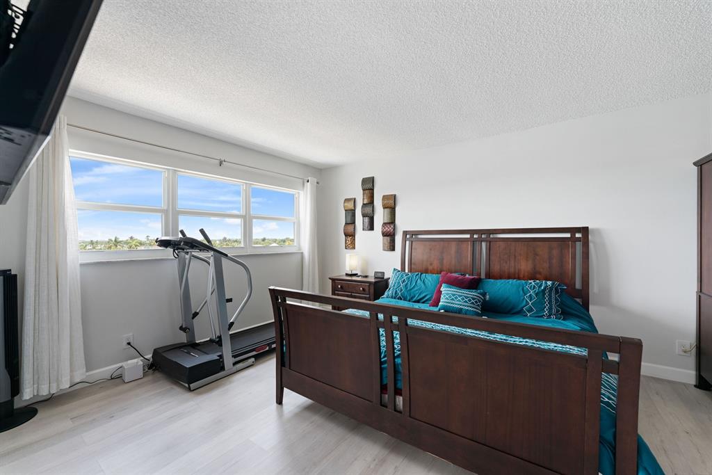 615 North Riverside Drive, Unit 502 Pompano Beach, FL 33062 - Photo 20 of 43 a living room with furniture and a flat screen tv
