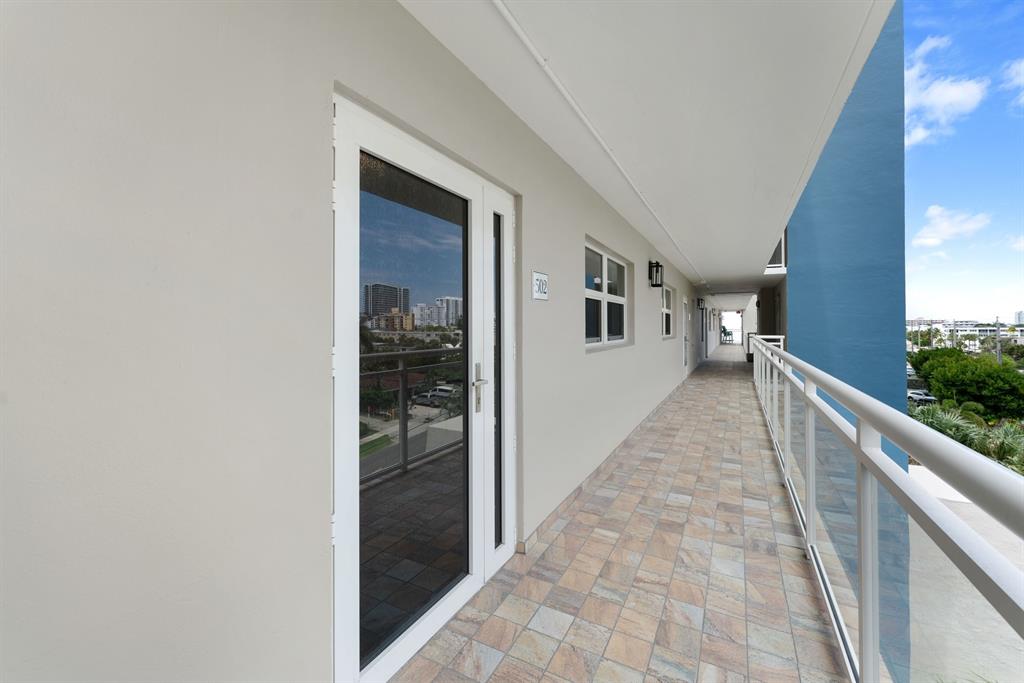 615 North Riverside Drive, Unit 502 Pompano Beach, FL 33062 - Photo 27 of 43 a view of a hallway with wooden floor and staircase