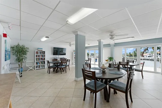 a view of a dining room with furniture and a potted plant