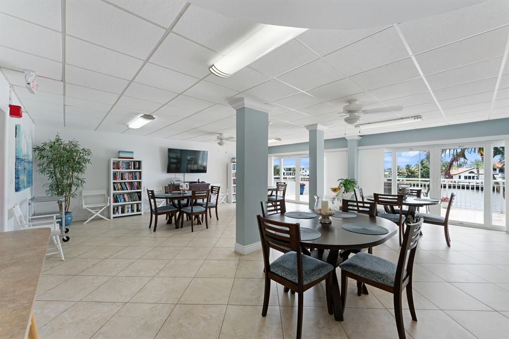 615 North Riverside Drive, Unit 502 Pompano Beach, FL 33062 - Photo 29 of 43 a view of a dining room with furniture and a potted plant