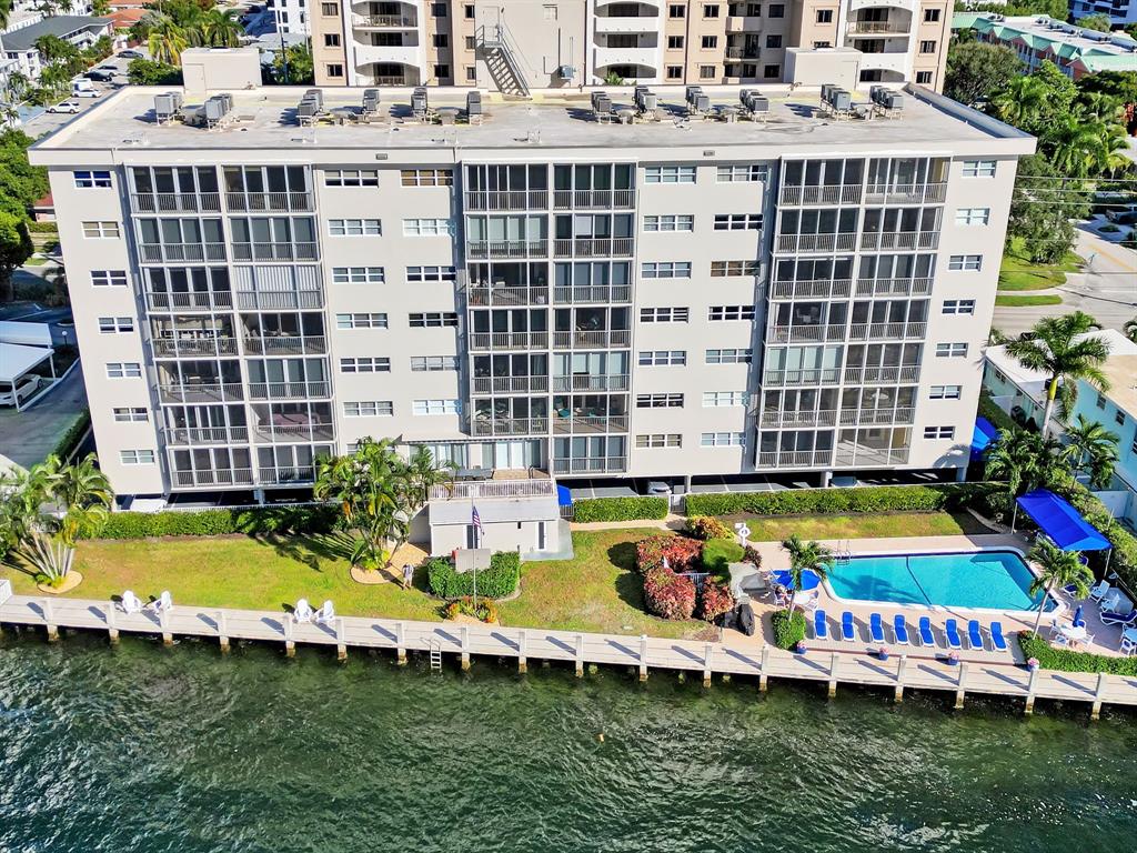 615 North Riverside Drive, Unit 502 Pompano Beach, FL 33062 - Photo 40 of 43 a view of a swimming pool with a lawn chairs and plants
