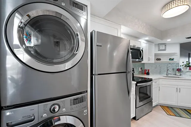 a kitchen with a refrigerator and washer