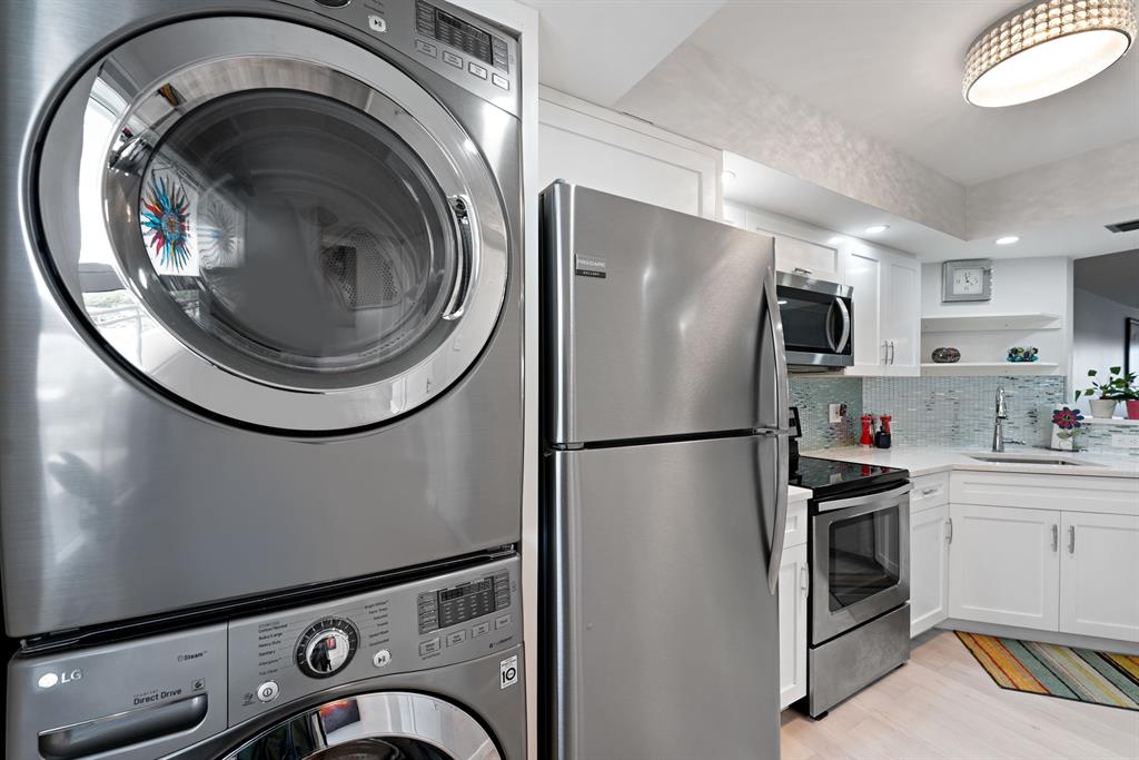615 North Riverside Drive, Unit 502 Pompano Beach, FL 33062 - Photo 4 of 43 a kitchen with a refrigerator and washer