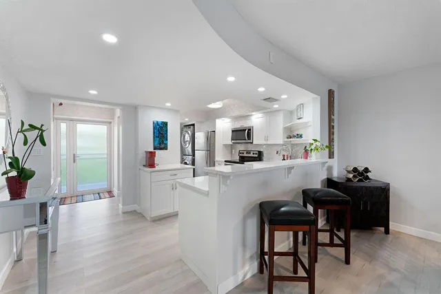 a kitchen with white cabinets and counter space