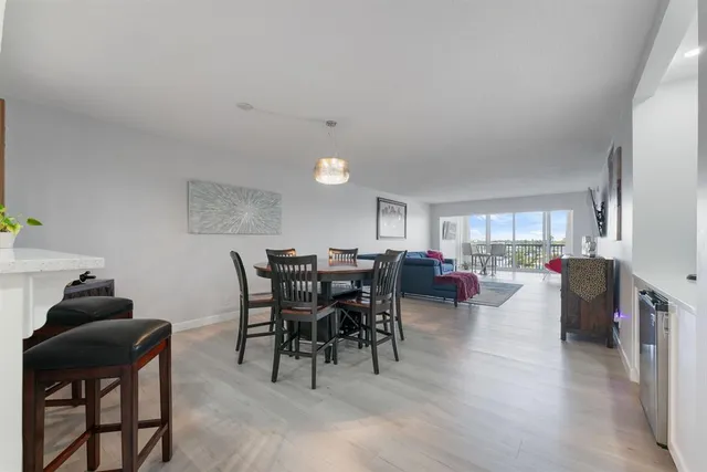 a living room with furniture a dining table and a potted plant