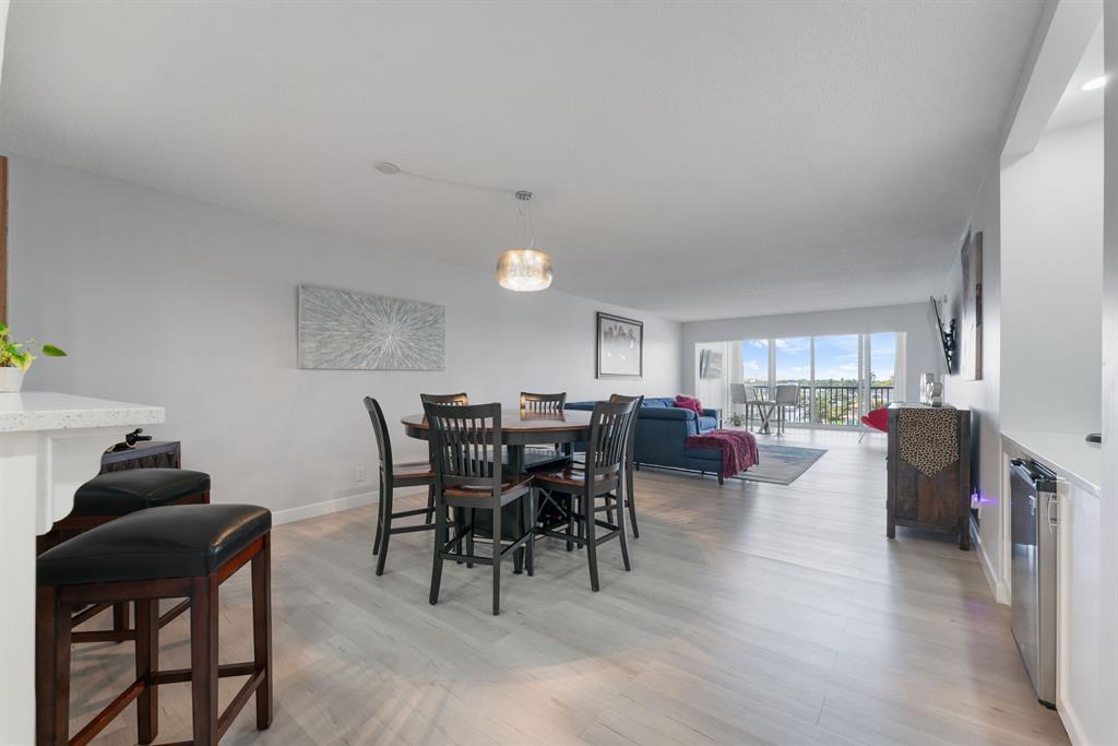 615 North Riverside Drive, Unit 502 Pompano Beach, FL 33062 - Photo 8 of 43 a living room with furniture a dining table and a potted plant