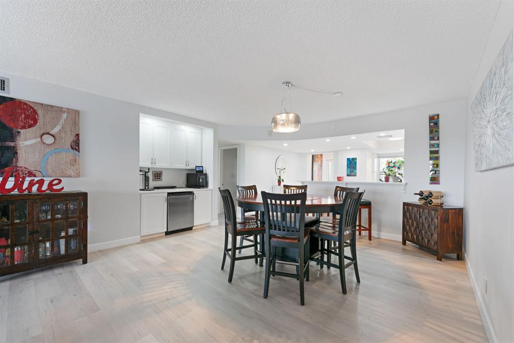 615 North Riverside Drive, Unit 502 Pompano Beach, FL 33062 - Photo 10 of 43 a view of a dining room with furniture and wooden floor