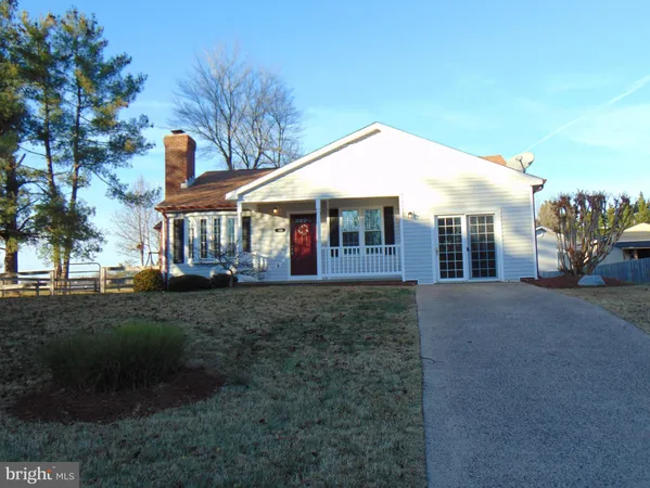 a view of a house with a yard and pathway