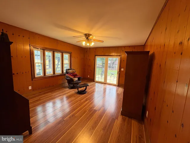 a view of a livingroom with furniture hardwood floor and a window