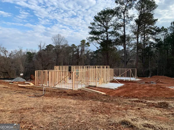 a view of a backyard with wooden fence
