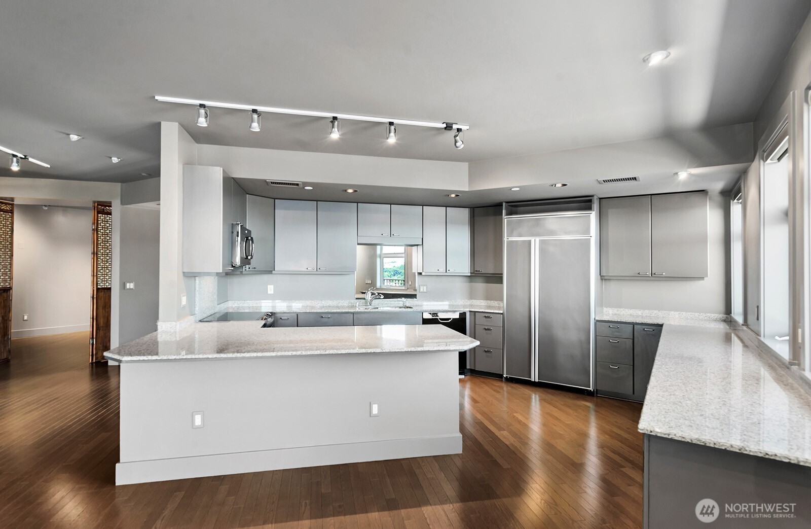 745 Bellevue Avenue East, Unit 402 Seattle, WA 98102 - Photo 16 of 39 a large kitchen with stainless steel appliances granite countertop a refrigerator and a stove