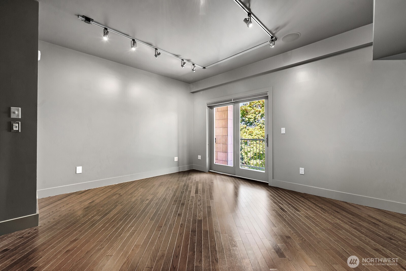 745 Bellevue Avenue East, Unit 402 Seattle, WA 98102 - Photo 25 of 39 an empty room with wooden floor and windows