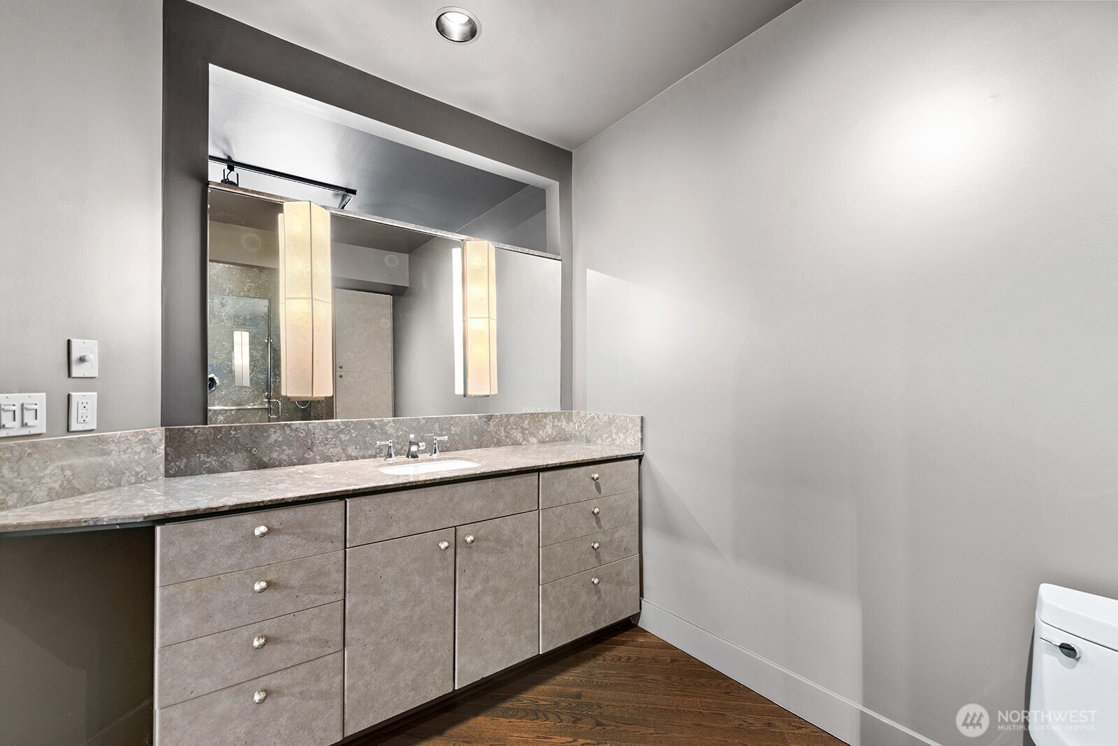 745 Bellevue Avenue East, Unit 402 Seattle, WA 98102 - Photo 31 of 39 a bathroom with a granite countertop sink and a mirror