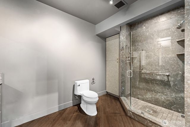 a bathroom with a toilet and a shower