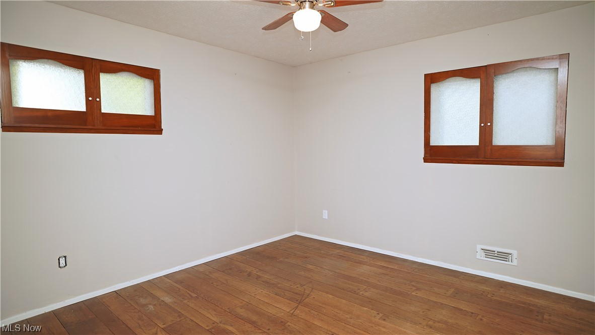6676 Rochelle Boulevard Parma Heights, OH 44130 - Photo 10 of 21 Spare room with ceiling fan and wood-type flooring