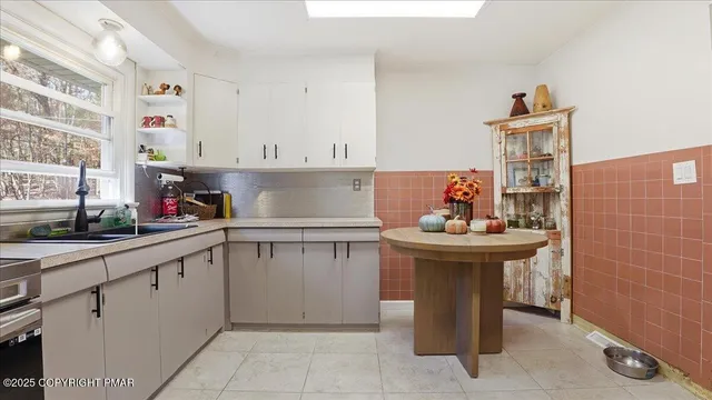 a kitchen with a refrigerator and cabinets