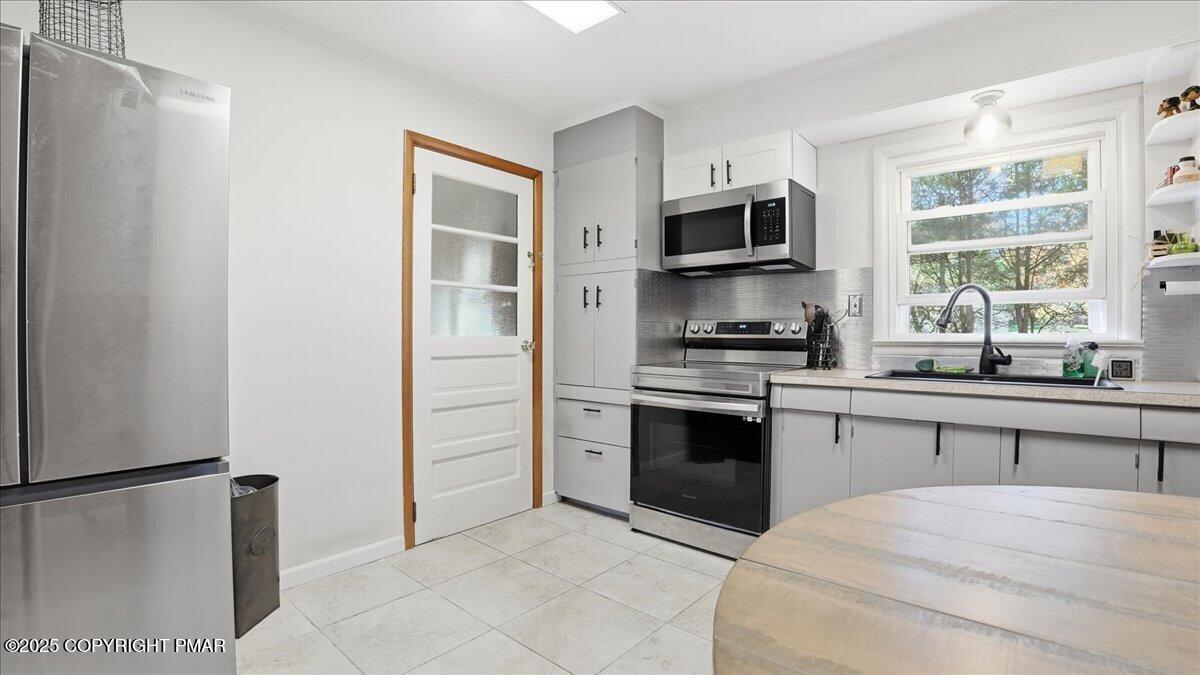 612 Prices Drive Cresco, PA 18326 - Photo 13 of 37 a kitchen with stainless steel appliances a refrigerator stove and microwave